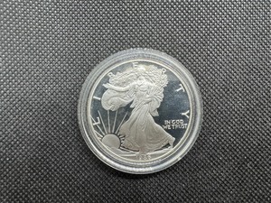 lot 15 image: Proof First Year of Issue 1986-S American Silver Eagle in Plastic Case PCGS Price Guide for a PF-69 is $129, PF-70 is $375
