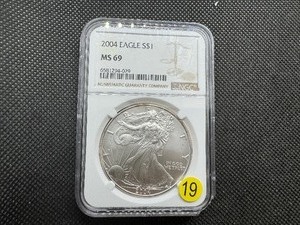 lot 19 image: 2004 1 Oz. Silver American Eagle NGC MS69 - NGC Price Guide is $65