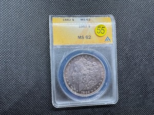 lot 55 image: 1882 Morgan Silver Dollar ANACS MS62 Attractively Purple Toned