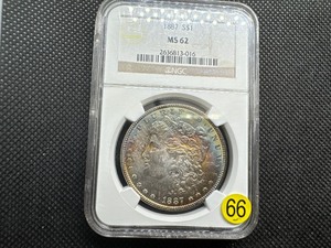 lot 66 image: 1887 Morgan Silver Dollar NGC MS62 - Rainbow Orange and Blue Toned