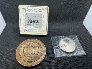 lot 16 image: 1963 2 12 Inch Idaho Territorial Centennial Medal w document 1989 $5.00 Marshall Islands First Man on the Moon Coin
