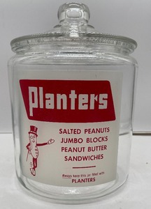 lot 147 image: Vintage Planters Peanuts Glass Counter Jar and Lid Red and White Label Mr. Peanut 1950s