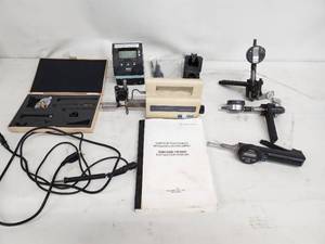 lot 25 image: Comprehensive lot featuring a Zeiss Surfcom 130A surface roughness measuring instrument and a selection of digital and analog gauges, probes, and precision measuring accessories.