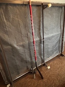 lot 25 image: Fishing Poles and Hockey Stick
