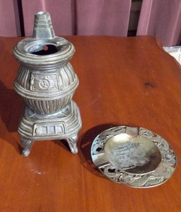 lot 145 image: two decorative items a miniature potbelly stove and a round ashtray.
