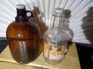 lot 365 image: 2 Brown A & W bottles, A&W Root Beer Bulls Eye logo on the lid.