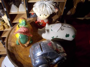 lot 211 image: The image shows a collection of vintage piggy banks