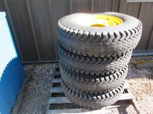 lot 26 image: 4 Wolf Paws Skid loader tires on 8 ...