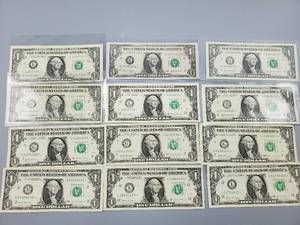 lot 76 image: 12 $1 U.S. Star Federal Reserve Notes--Some Are Crisp and in Sleeves