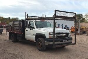 2007 White Chevy 3500 Diesel truck, flatbed with side rails, rack extending over the cab
