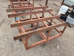 lot 38 image: Heavy-duty industrial rolling cart probably designed for transporting pipes or beams 62  l x 48 w x 33