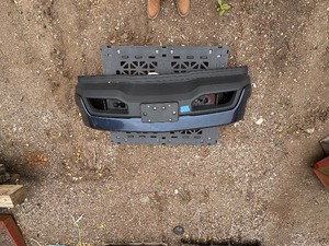 lot 62 image: Vehicle Front Bumper Assembly w fog light openings, license plate mounting bracket and two-tone color scheme.