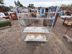 lot 72 image: Metal rolling storage cart or cage with two fixed shelves 70 x 48