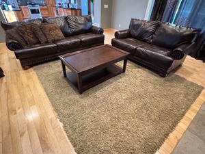 lot 25 image: LR - Faux Leather Sofa, Loveseat, Coffee Table with Surface Wear, and Rug Set