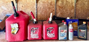 lot 63 image: S - Group of Empty Gas Cans and Assorted Automotive Oil Containers