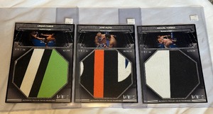 lot 93A image: (3) Jumbo Octogon Mat Piece Authentic WEC Cards - Uriah Faber, Jose Aldo, Miguel Torres 2011 Topps