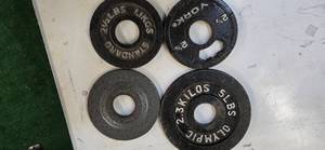 lot 9 image: Three 2.5LB 2-Inch and 0ne 5LB  Weight Plates (Used)