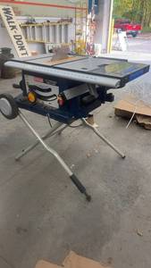 lot 1720 image: Ryobi 10 Inch Portable Table Saw with Folding Stand and Wheels