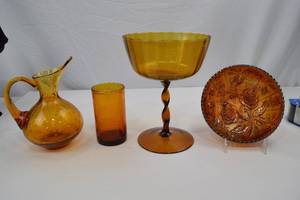 lot 229 image: Vintage Amber Glass Assortment Pitcher, Tumbler, Compote, Carnival Bowl