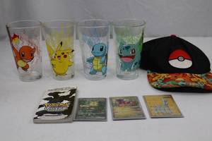 lot 74 image: Pokemon Collectibles Lot 4 Glasses, Cap, Cards, Sticker Book