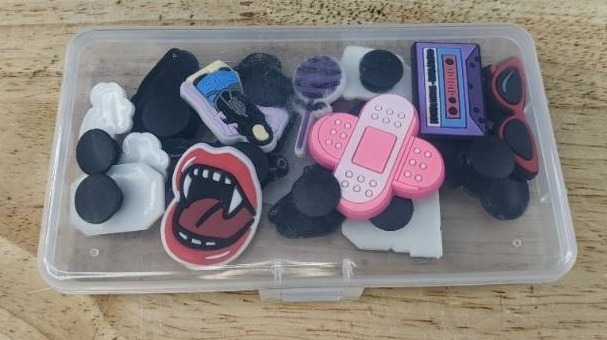 lot 104H image: 16 Brand New Olivia Rodrigo Music Character Croc Charms with Case
