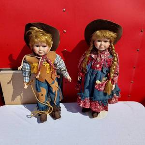 lot 12 image: Western Cowboy and Cowgirl Porcelain Dolls, Each approximately 16 inches tall