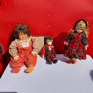 lot 13 image: Lot of 3 Porcelain Dolls Including One with Curly Hair and One with Holiday Attire