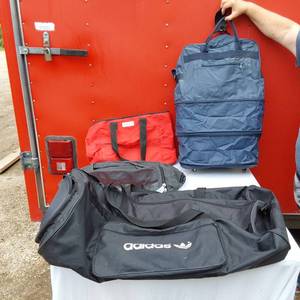 lot 17 image: Adidas Black Duffel, Grey Gym Bag, Blue Carry-On, and Red Tote Bag.