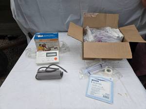 lot 395 image: Omron Automatic Inflation Blood Pressure Monitor Model HEM-713C, McKesson Split Sponges and Medical Supplies