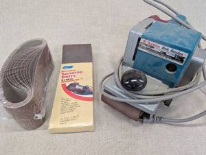 lot 65 image: Makita Belt Sander with Sanding Belts