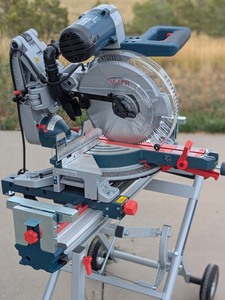 lot 3 image: Bosch Miter Saw with Rolling Stand and Tenryu Blade