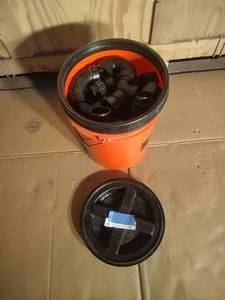 lot 72 image: Bucket with Black Plumbing Fittings