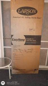 lot 83 image: Larson EasyHang Storm Door in Factory Packaging