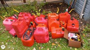 lot 101 image: Collection of 15 Plastic Gas Cans with Funnels and Spouts