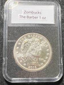 lot 54 image: 1 TROY OZ .999 FINE SILVER ZOMBUCKS THE BARBER ROUND SLABBED