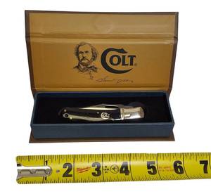 lot 48 image: COLT Tiger Paw Lockback Brown Folding Knife displayed in a collectors box.