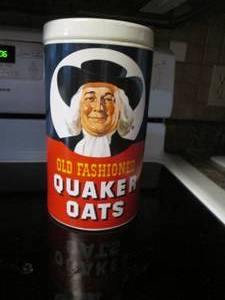 lot 49 image: Ceramic Quaker Oats Canister shaped...