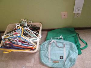 lot 182 image: Laundry basket with plastic hangers...