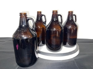 lot 39 image: Set of 4 Amber Glass Growlers 64 oz with Handles