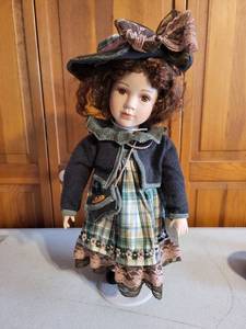 lot 12K image: Leonardo Collection Porcelain Doll with Curly Hair and Plaid Dress 19 Inch