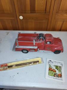 lot 28K image: Vintage Red Toy Fire Truck, Nursery Stories Booklet, and Sealed Flute Pen Lot