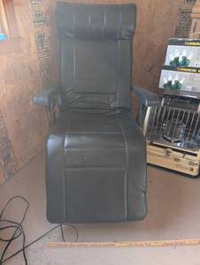 lot 13 image: Black Electric Vibrating and Reclining Faux Leather Chair with Folding Armrests