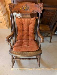 lot 34 image: Vintage Wooden Rocking Chair with Floral Motif and Cushion