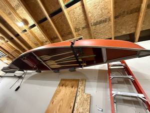 lot 8 image: Red Canoe with Oars and Life Jackets