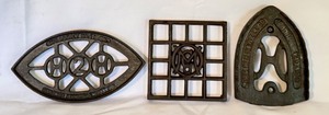 lot 94D image: LR - Set of 3 Antique Cast Iron Trivets Including The WM Howell Co and H2H Pattern