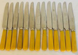 lot 451C image: LR - Set of 12 Caburo Stainless Steel Table Knives with Yellow Handles