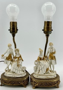 lot 94 image: Pair of Porcelain Figural Lamps with Ornate Gilt Accented Bases