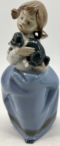 lot 292 image: Lladro Porcelain Figurine Girl In Blue Dress Holding Puppy
