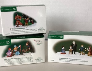 lot 169 image: Dept 56 Dickens Village Decorating With Holiday Greenery  A Peaceful Glow on Christmas Eve  A Christmas Beginning