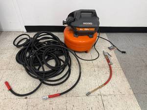 lot 1 image: Ridgid 6 Gallon 150 PSI Pancake Air Compressor with Hose and Inflation Gun